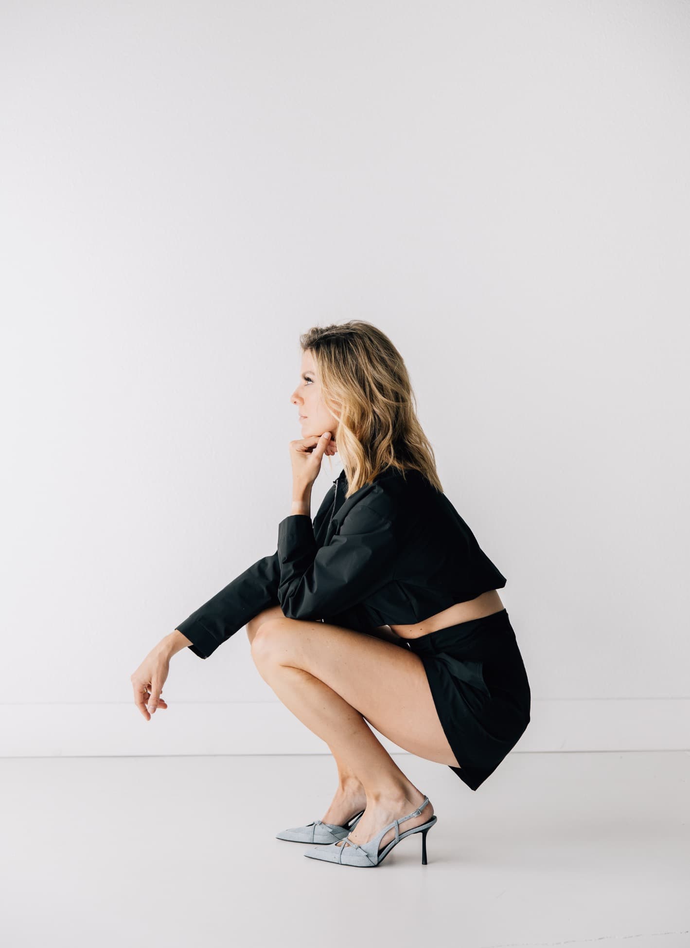 Close-up portrait of Keeli against a dark studio background.